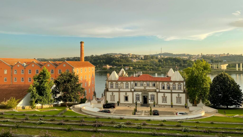 Elegant view of Pestana Palácio do Freixo by the river in Porto, Portugal during summer.