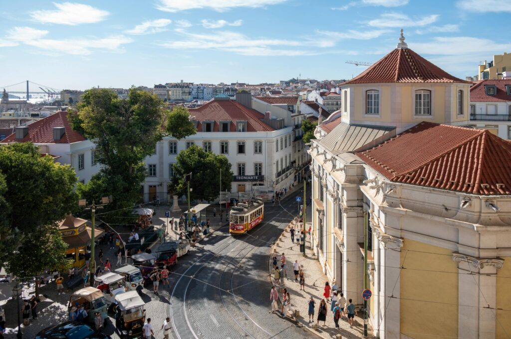 Discover the vibrant cityscape of Lisbon with historic trams and architecture, perfect for travel enthusiasts.